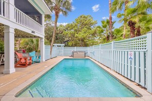 Enjoy the private yard, complete with a pristine pool, spa, and large screened porch—perfect for family gatherings.