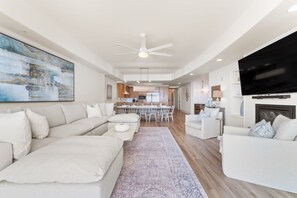 Living room has a flat-screen TV and plenty of seating
