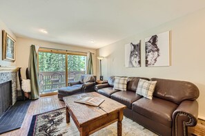living room w fireplace looking out to slopes