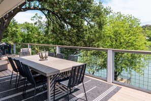Alfresco enchantment: Savor delightful meals and unforgettable moments in this 8-seater outdoor dining oasis, nestled amidst a serene lakeside and tree-lined setting.