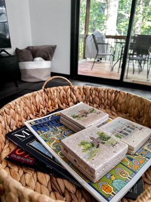 Notre Dame coasters on the living room ottoman.