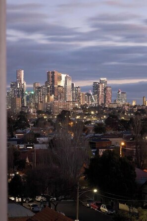 Out on the balcony, glistening skyline views await.