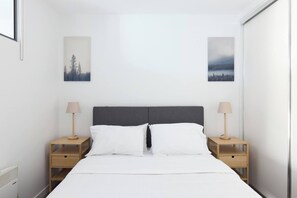 The bedroom houses a queen bed and has plenty of storage space in the floor-to-ceiling wardrobe for short and long-term stays. 
