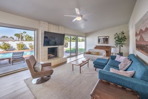 Living Room: Bright and airy space with stunning pool views, perfect for relaxation and fun!