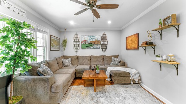 Relax on the large comfortable couch in front of a large screen TV