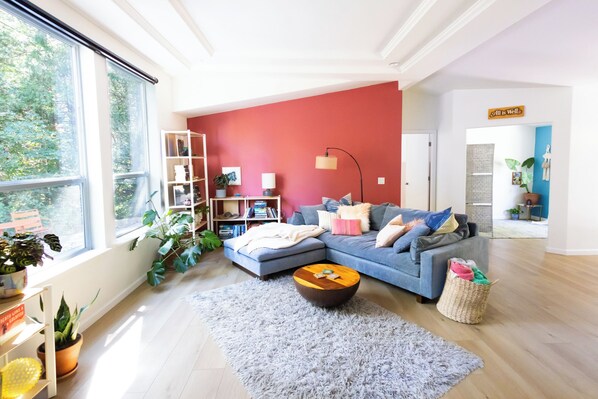 Living Room. Floor to ceiling windows bring the forest inside, open concept.