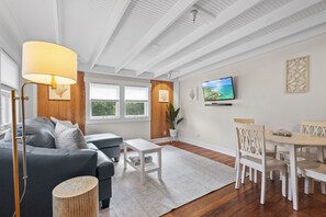 Comfortable furnishings and stylish decor in an open floor plan with kitchen and dining area.