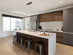 1st Floor: Fully equipped modern kitchen completely stocked with all culinary essentials and includes high-end Cafe stainless steel appliances.