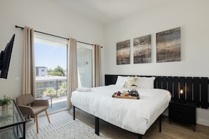 2nd Floor: Primary Bedroom featuring a King Bed, a Smart TV, a private balcony, and an ensuite primary bathroom.
