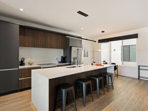 1st Floor: Fully equipped modern kitchen completely stocked with all culinary essentials and includes high-end Cafe stainless steel appliances.