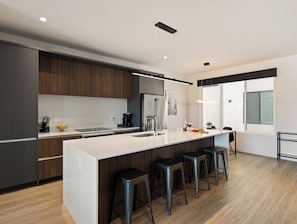 1st Floor: Fully equipped modern kitchen completely stocked with all culinary essentials and includes high-end Cafe stainless steel appliances.