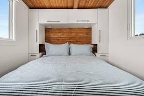Back Queen bed with plenty of storage space.