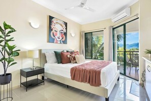 Bedroom with queen bed, AC, ceiling fan and access to the balcony