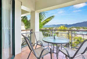 Balcony with dining table and chairs, mountains views