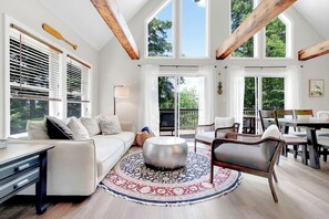 Stunning floor-to-ceiling windows in the living room with plenty of comfortable seating.
