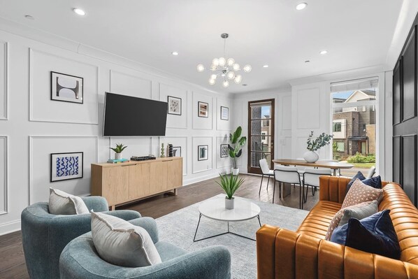 Smart TV in the living room with all the streaming apps. Lots of natural light and plenty of seating for your comfort.