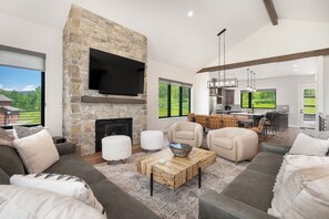Main level living area with plenty of seating, fireplace, and amazing views