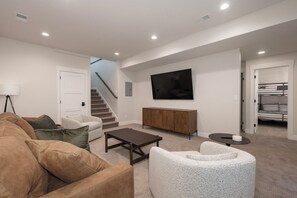 Lower level living area featuring 75" smart TV