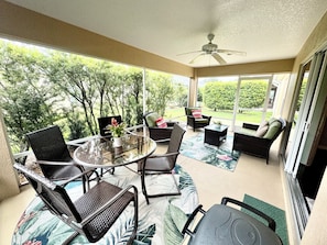 Screened-in Lanai with ample seating and an electric grill. 