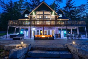Experience the serene evening view of Greenstone Manor, complete with a Fire table