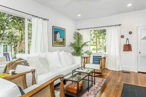The living room looks out over a quiet, tree-lined street. 