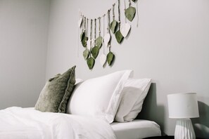 Full pillows and boho touches add to the charm of this master bedroom.