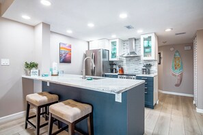 Sleek and modern kitchen with stainless steel appliances and bar seating