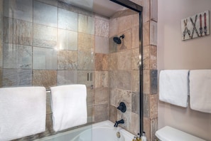 Bathroom: single-sink vanity, closet, bathtub/shower combo