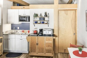 Enjoy the convenience of a fully equipped kitchen, featuring refrigerator, microwave, coffee maker, cooktop, toaster oven, dishware and utensils.