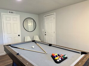 The pool table offers both a stylish centerpiece and hours of entertainment.