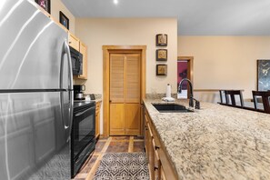 Full kitchen with breakfast bar, new appliances, and coffee maker.