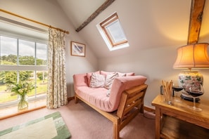 Hayloft, Brancaster: The first floor sitting room with a view of the village green