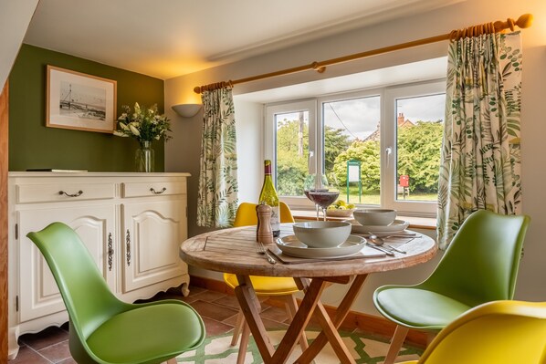 Hayloft, Brancaster: A bright, dual aspect dining room with views over the village