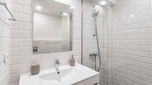 Embrace the clean lines and modern simplicity of our bathroom, a tranquil space where you can unwind with a hot shower #ample #relax
