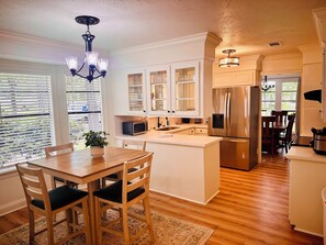 Fully furnished kitchen with eat in dinette for four. 