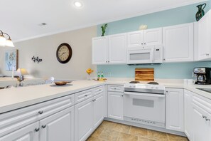 Prepare your favorite meals in the modern kitchen, complete with all the necessary appliances and cookware.