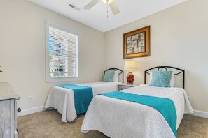 The second bedroom is equipped with two twin-size beds, making it perfect for kids or additional guests.
