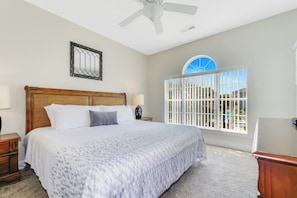 Enjoy a restful night in the master bedroom featuring a comfortable king-size bed.