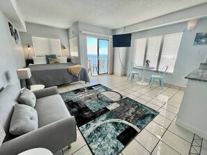 Unwind in your ocean oasis, with a dreamy bed and a cozy couch in the living area, offering a peaceful escape with stunning oceanfront surroundings.
