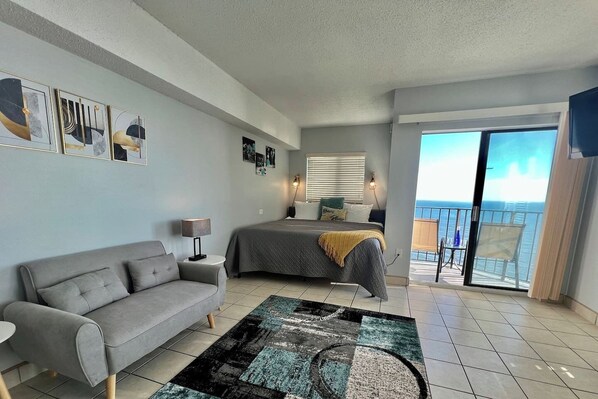 Unwind in your ocean oasis, with a dreamy bed and a cozy couch in the living area, offering a peaceful escape with stunning oceanfront surroundings.