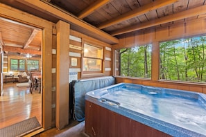 Unwind in the private 4-person hot tub, surrounded by serene forest views. This cozy, enclosed space offers the perfect place to relax after a day of adventure.