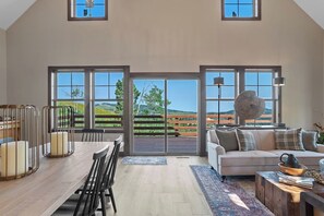 Delight in our sun-kissed living and dining room, where enormous windows invite natural light and reveal stunning, whimsical views!