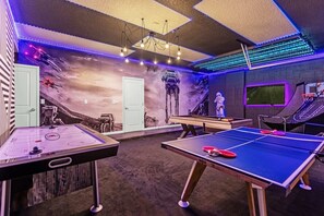 Garage-turned-games-room with air hockey, table tennis and billiards