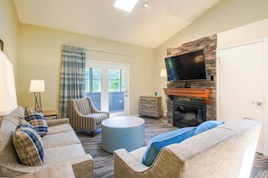 And living area with a stone fireplace