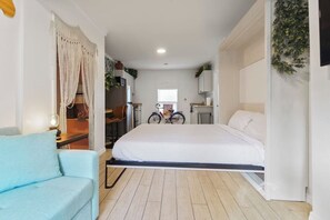 [Living area] Memory foam Murphy bed easily folds up when not in use.