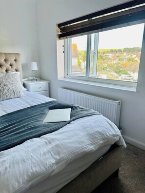 Bedroom 1 is the largest bedroom. It’s located upstairs. It boasts 3 windows, 2 of which look out onto rolling hills with horses usually grazing. This room consists of a king sized bed, triple wardrobes, chest of drawers and a comfy love sofa. 
