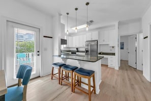 Well equipped open kitchen with island seating.