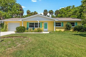 A bright, welcoming exterior full of Florida charm and offering garage parking