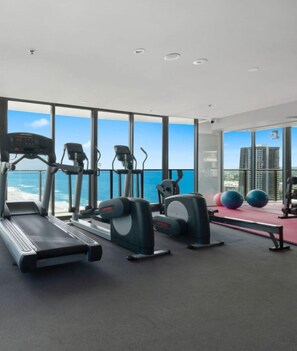 Indulge in a fully equipped gym located on a higher floor, allowing you to work out while enjoying a breathtaking 180-degree view of the ocean.