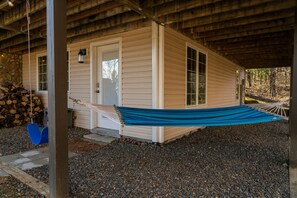 Swing and Hammock outside downstairs door near fire pit